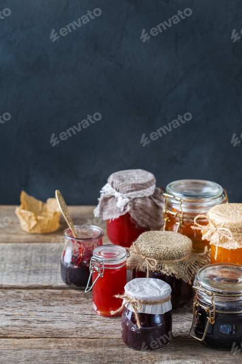 Preview: Assortment of seasonal berries and fruits jams in jars