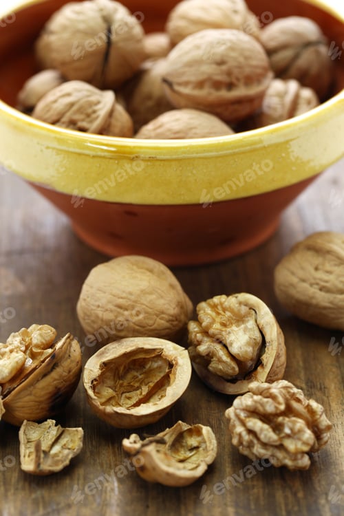 Preview: walnuts, kernel and shell on wooden background