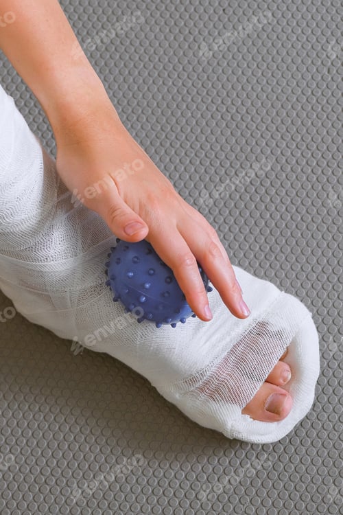 Preview: woman with a leg injury in a cast restores muscle function and rehabilitation with mfr massage, myof