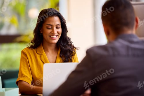 Preview: Mature Male And Female Business Colleagues Meeting Around Laptop In Modern Office