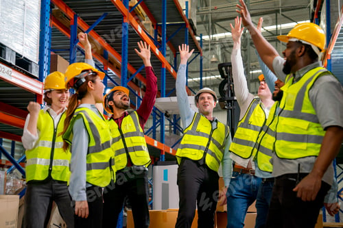 Preview: Multi-ethnic warehouse workers raise hands up to show action of very happy from the successful
