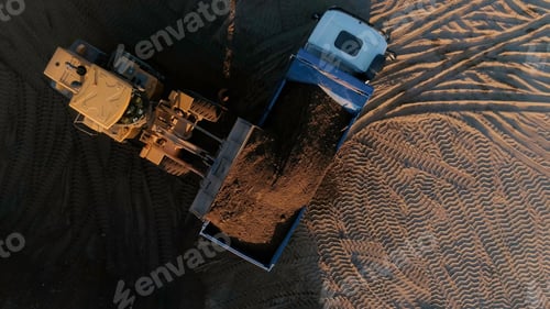 Preview: Sand mining industry, sand mine at the quarry. Scene. Aerial top view of a bulldozer machine putting
