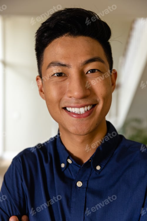 Preview: Portrait of happy asian man at home