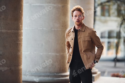 Preview: Elegant young man in formal classy clothes outdoors in the city