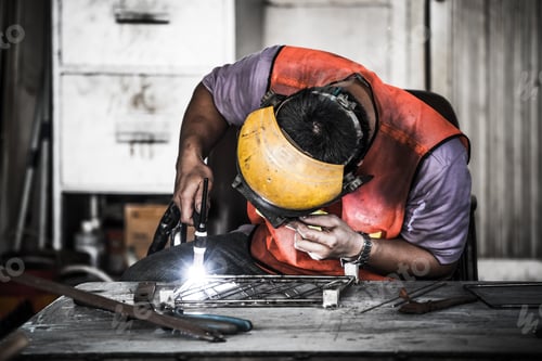 Preview: Asian technician engineer using tig welder in factory's workshop