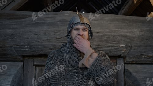 Preview: Ancient russian bogatyr standing by wooden beam izba wall and whistling. Media. Concept of ancient