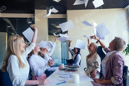 Preview: multiracial group of young women editor of famous magazine collaborating throwing paper