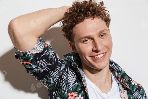 Preview: Image of curly cheerful man posing and laughing at camera