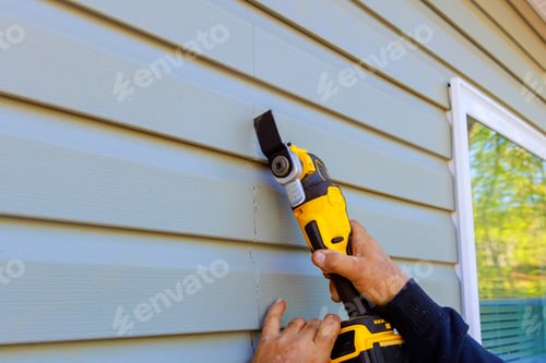 Preview: As part of reconstruction of house, a multi tool is used to remove damaged vinyl siding