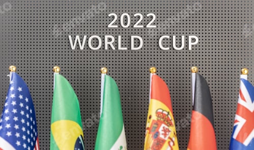 Preview: 2022 World Cup text on a board and group of different flags of participating countries