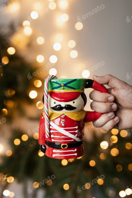 Preview: Hand holding a nutcracker mug