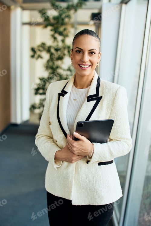 Preview: Confident Professional Woman Holding a Tablet in Modern Office Setting