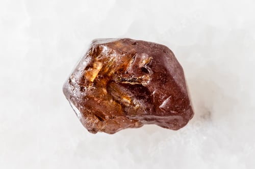 Preview: sample of rough hyacinth zircon crystal on white