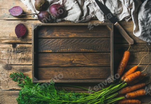 Preview: Garden carrots and beetroots with wooden tray in center