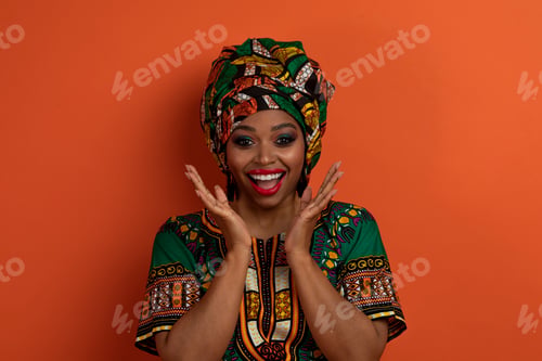 Preview: Portrait of amazed black woman gesturing on orange