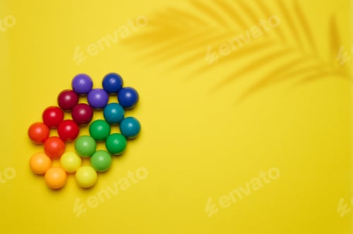 Preview: Abstract background with multi-colored plastic balls on a yellow background