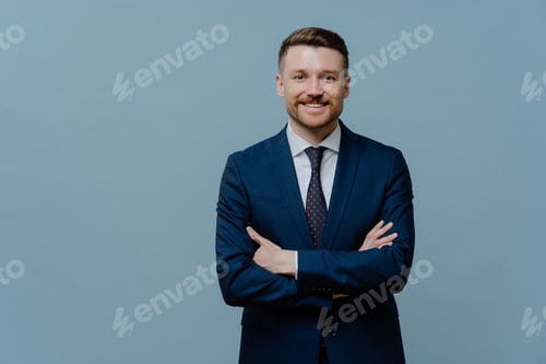 Preview: self confident bearded male entrepreneur keeps arms crossed smiles gladfully