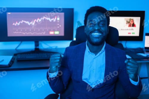 Preview: Young successful business man celebrating his profits on his investments in the market
