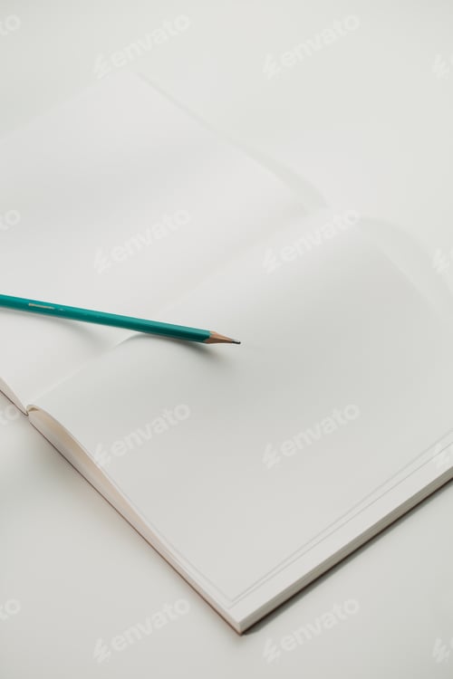 Preview: Green pencil on a book