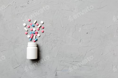 Preview: Multicolored pills and capsules in plastic bottle on Colored background, copy space.