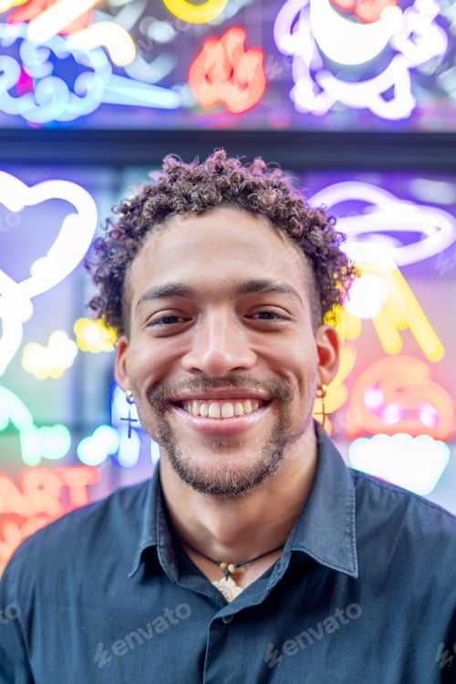 Preview: Close-Up of Man with Neon Signs in Background