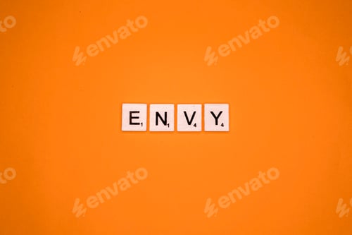 Preview: Envy scrabble letters word on a orange background