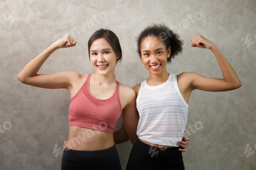 Preview: International Women's Day. two diverse young women doing yoga at home.