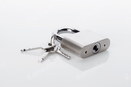 Preview: Silver padlock and keys on a white surface during daytime