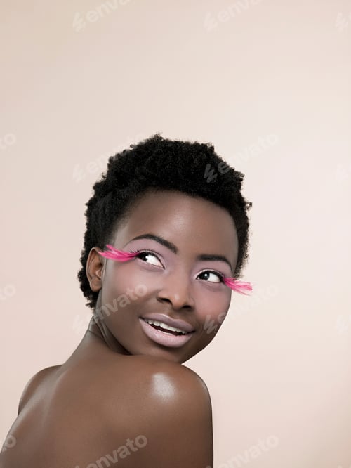 Preview: Woman with whimsical pink eyelashes flashing a joyful smile