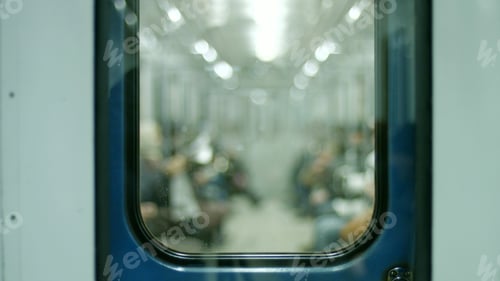 Preview: Blurred image of people in underground transport.
