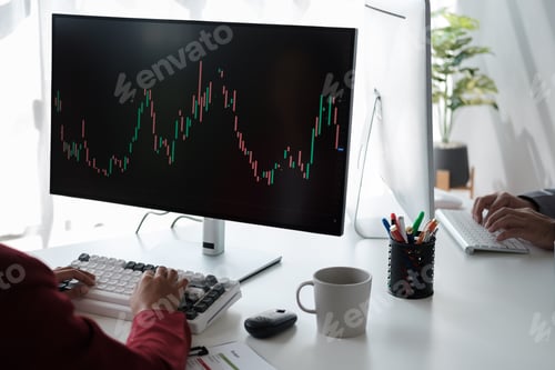 Preview: Close up view of young business woman explaining the trend of the graph to her coworker using deskto