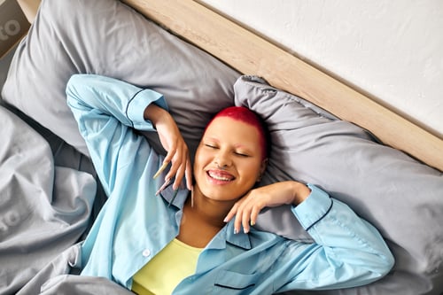 Preview: A young woman relaxes joyfully at home in comfortable pajamas during a lazy afternoon
