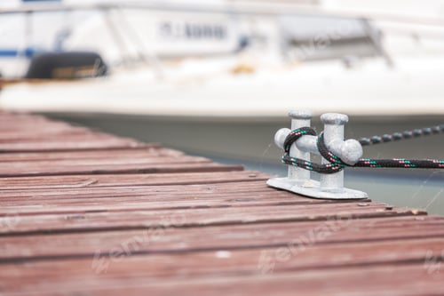 Preview: Knotted and tied up rope on wooden pier