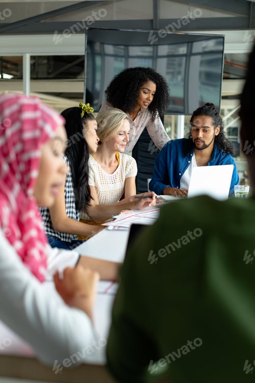 Preview: Diverse business people working together on laptop at conference room