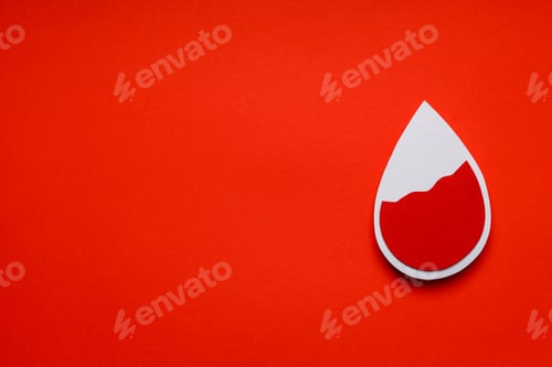Preview: Red blood drop shape placed on bright orange background
