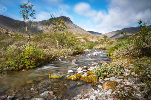Preview: Beautiful landscape of the Khibiny mountains with rocks and a mountain stream on a sunny day.