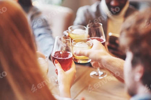 Preview: Hands of people with glasses of whiskey or wine, celebrating