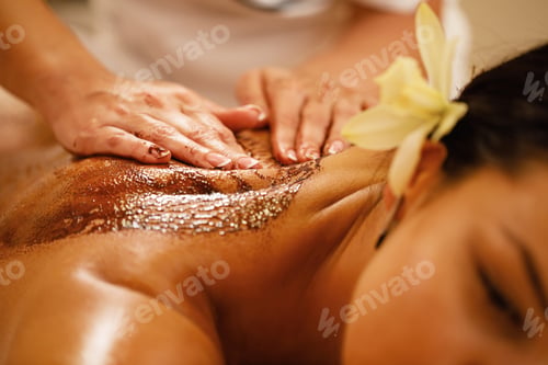 Preview: Close-up of woman having hot chocolate massage at the spa.