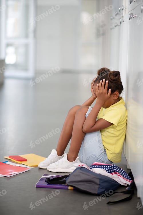 Preview: African-American girl crying after bullying by pupils