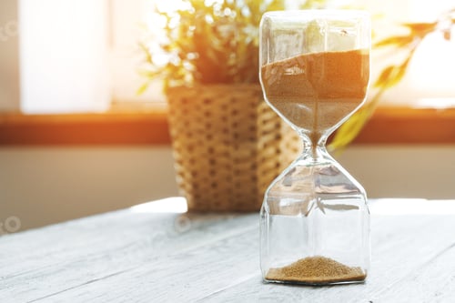 Preview: Sandglass on wooden bakground closeup. Time concept