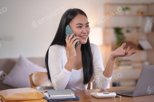 Preview: Cheerful Woman on Phone Call at Home Office