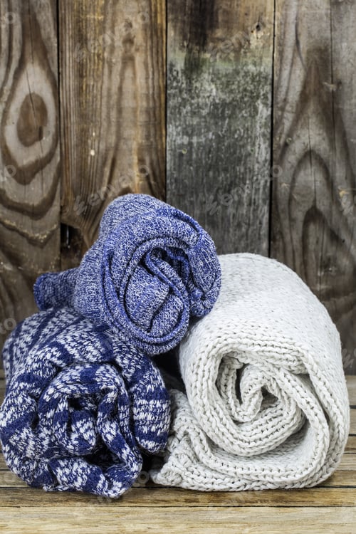 Preview: Sweaters on wooden background