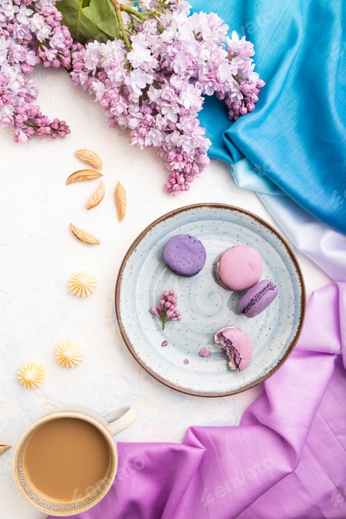 Preview: Purple macarons or macaroons cakes with cup of coffee on a white concrete background