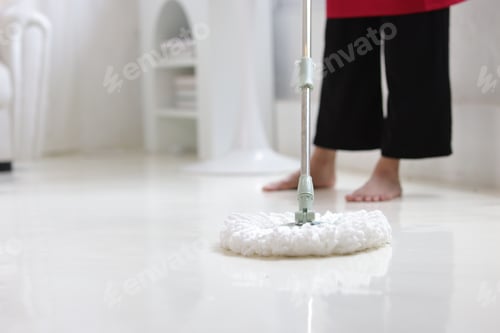 Preview: Cleaner is mopping floors at home with a mop.