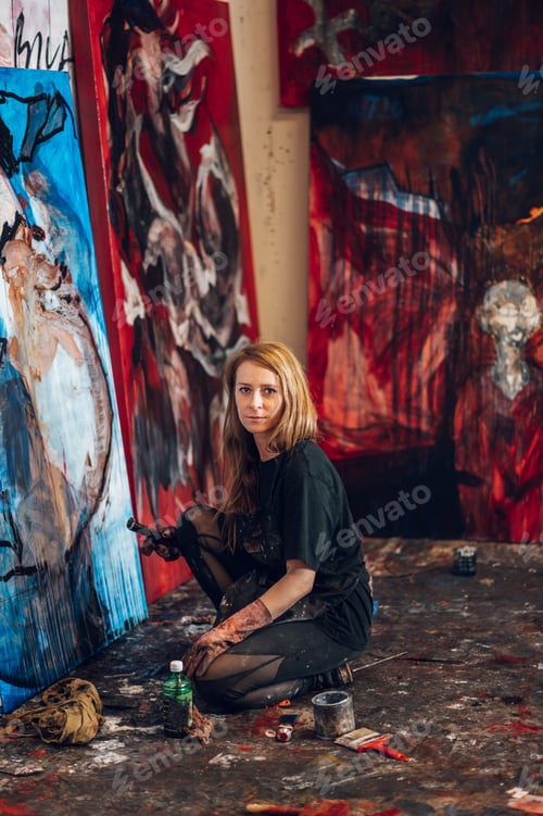 Preview: Female painter artist painting and creating her art in a creative studio