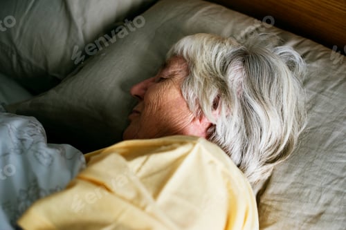 Preview: Elderly caucasian woman sleeping on the bed