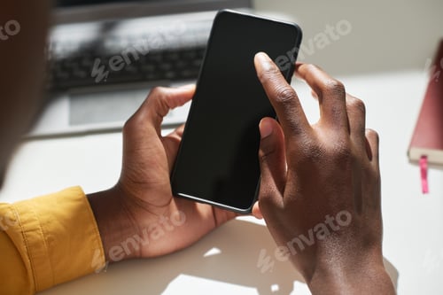 Preview: Close-up of hands of young male zoomer pointing at smartphone screen