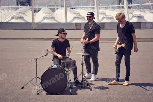 Preview: rock band in black clothing playing music on street