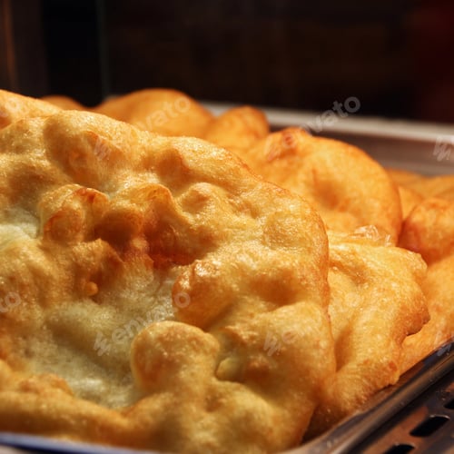Preview: Closeup of a freshly deep fried Hungarian flatbread Langos