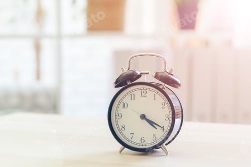 Preview: Morning sun. Alarm clock on a beautiful background